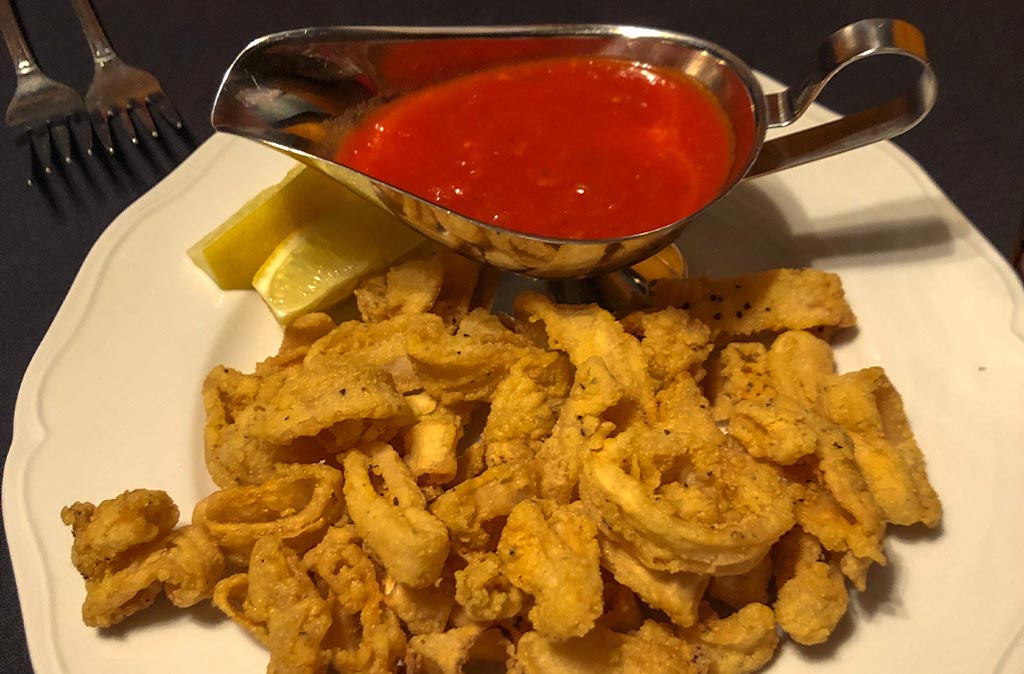 Photo of Garlic Mike's fried calamari served with marinara sauce.