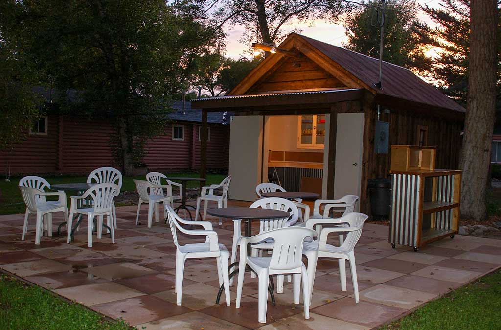 Photo of outdoor patio at Island Acres Resort Motel in Gunnison, Colorado at dusk