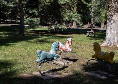 Photo of three horse spring riders in the large park at Island Acres Resort Motel.