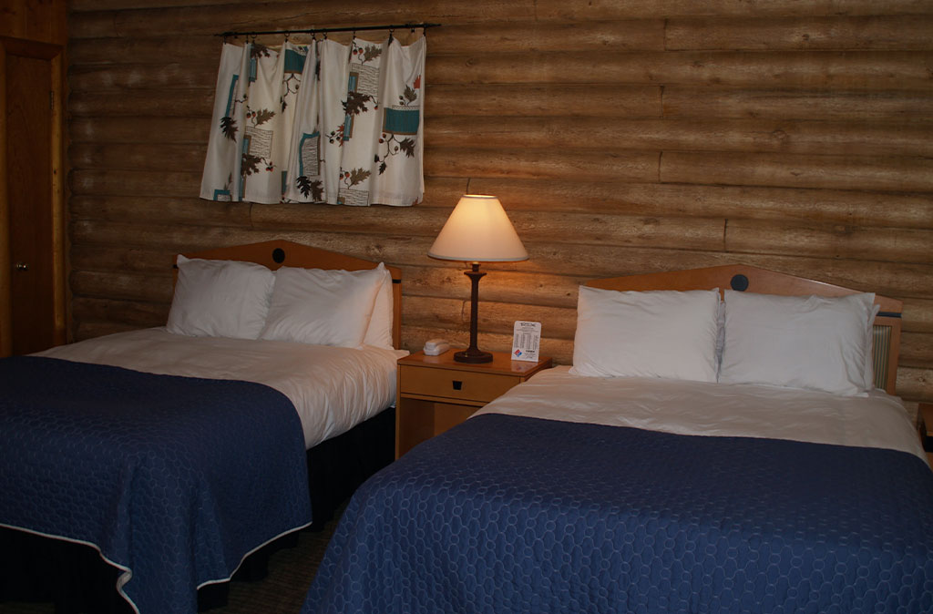 Photo of Queen Studio Unit at Island Acres Resort Motel showing two queen beds and vintage curtains.
