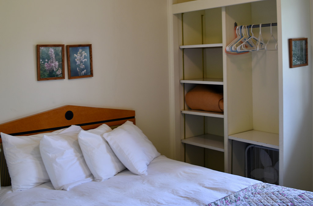 Photo of bed and closet space in Unit 2 at Island Acres Resort Motel