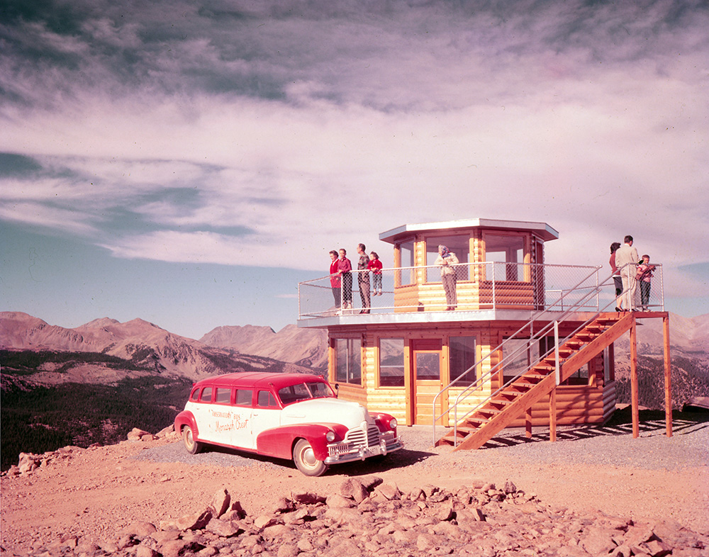 Elmo Bevington, owner of Monarch Ski Resort, would take tourists up to the top of the Monarch Crest in his signature red automobile. This image is from the Salida Museum Negatives Collection.
